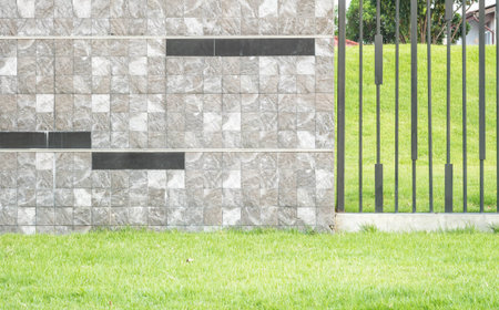 Closeup surface brick marble stone wall with green grass texture background