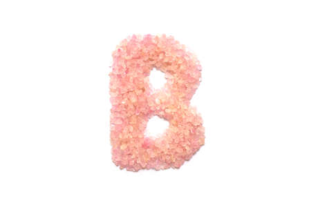 Closeup pile of pink crystal stone in B english alphabet isolated on white backgroundの写真素材