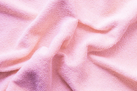 Closeup wrinkled pink napkin fabric backgroundの写真素材