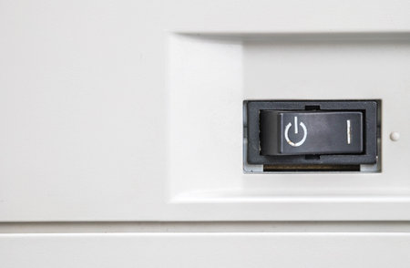 Closeup power button at the photocopier background