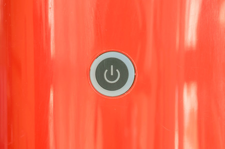 Closeup power button at red coffee machine backgroundの写真素材