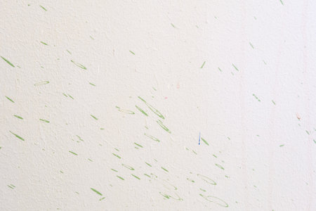 Dirty white painted cement wall with green color drop texture backgroundの写真素材