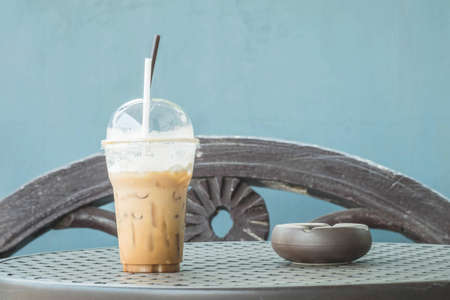 Closeup a plastic cup of coffee on the tableの写真素材