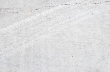 Closeup surface concrete floor with tire tracks texture backgroundの写真素材