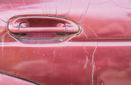 Closeup surface handle of old red car texture backgroundの写真素材