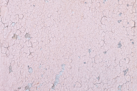Closeup pale color and peeling of painted pink cement wall texture backgroundの写真素材