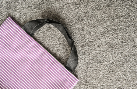 Purple cloth bag on gray carpet backgroundの写真素材