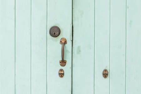 Closeup old  and pale green wooden door backgroundの写真素材