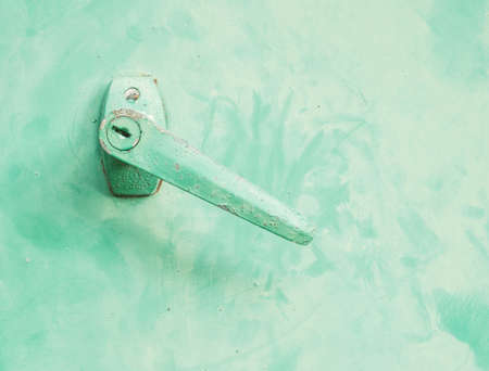 Closeup handle in front of green electrical box backgroundの写真素材