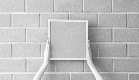 Closeup cork board in hand of woman in black and white toneの写真素材