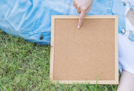 Closeup cork board  beside the body of womanの写真素材