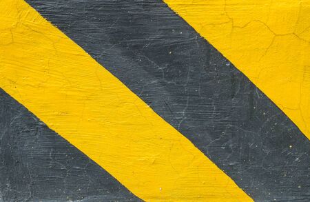 Closeup surface of old yellow and black painted cement floor texture background sign for let car know this area not allow for parkingの写真素材