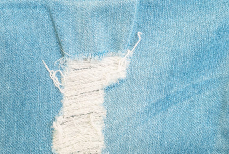 Closeup surface of old blue jean trousers fabric texture background