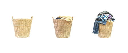 Closeup empty wood weave basket for used clothes and wood weave basket with pile of clothes in house isolated on white backgroundの写真素材