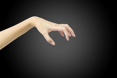 Closeup action of woman hand catching and hold something in hand isolated on black backgroundの写真素材