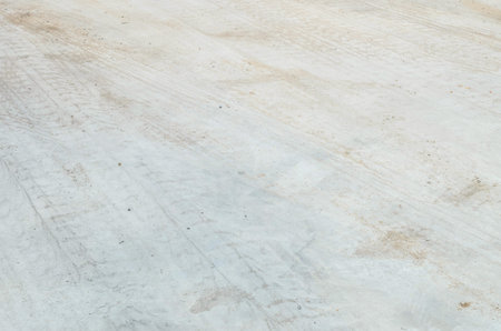 Closeup surface concrete floor with tire tracks textured background
