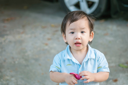 Closeup asian naughty boy playing at the outdoorの写真素材
