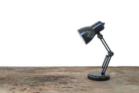 Closeup small lamp on wood desk isolated on white background with copy spaceの写真素材
