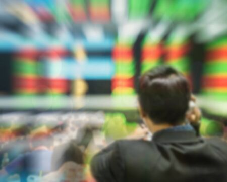 Motion blur of trader in the marketing room on blurred stock board background in business conceptの写真素材