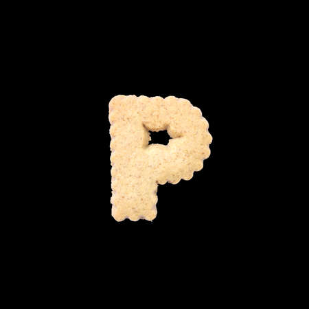 Closeup brown biscuit in P english alphabet isolated on black background with clipping pathの写真素材