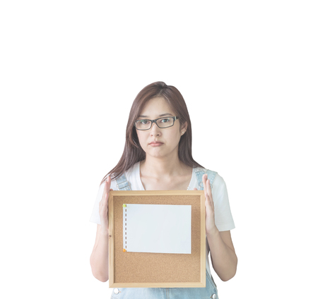 Closeup asian woman with cork board in hand with boring face isolated on white backgroundの写真素材