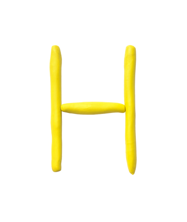 Closeup yellow plasticine for kid in H alphabet isolated on white backgroundの写真素材