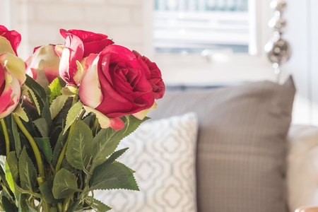 Closeup fake red rose flowers on blurred room view backgroundの写真素材