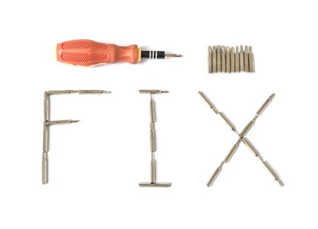 Closeup screwdriver head in fix word and handle isolated on white backgroundの写真素材