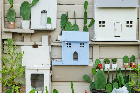 Closeup decoration on old wood wall of house by cactus and wooden box in house shapeの写真素材
