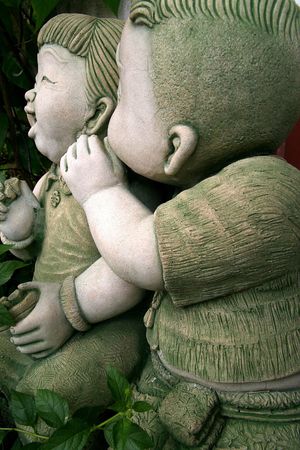 Stone Sculpture of a Boy and a Girlの写真素材