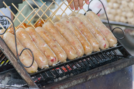 Thai sausage traditional style. Thais call " Sai krok isan orThai sausage, homemade northern Thai sausage on grill. Thai local food, Asian thai Food or Delicious thai sausages on grillの写真素材