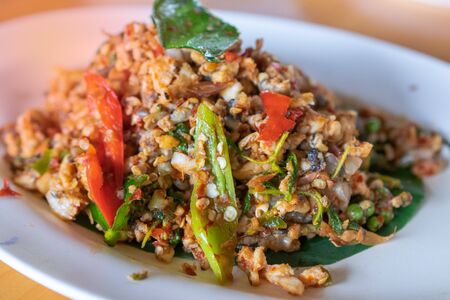 Close up Fried Spicy Frog with herb on white plate  is thai food and thailandの写真素材