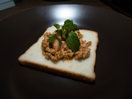 Spicy Minced Pork homemade  on bread made by his wife.の写真素材