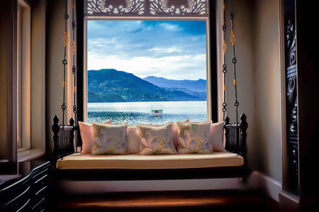 Vintage sofa with lamp on glass window.の写真素材