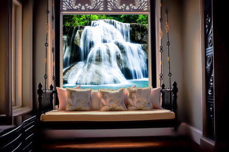 Vintage sofa with lamp on glass window.の写真素材