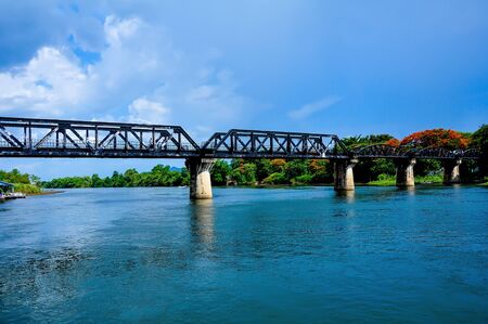 The railway bridge over the river that is made of steel.の写真素材