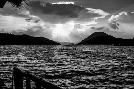 Lake with bright blue sky, white clouds. Abstract black and white tone.の写真素材