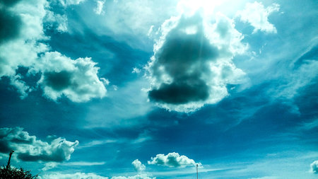 Clear with white clouds, blue skies, open air.