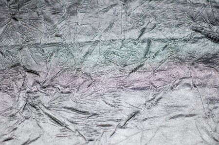 Silver wrinkled sheet metal is light, abstract images.の写真素材