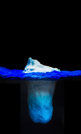 The Iceberg model, which likens human communication to iceberg ice cubes with a visible outflow of water. The ratio is very small compared to the underwater part.の写真素材