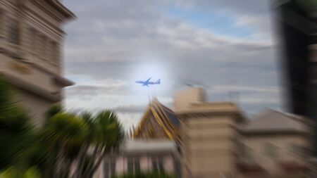 The plane flies in very high clouds on a sunny day.の写真素材