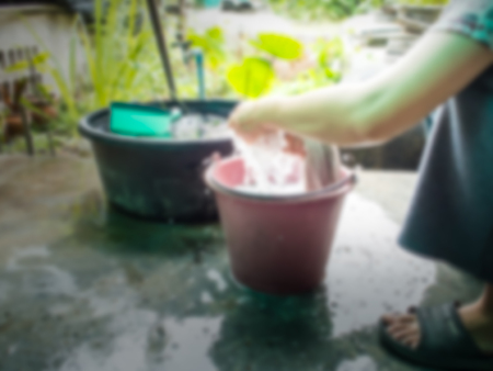 Girls wash the laundry outside the house. Abstract image blurの写真素材