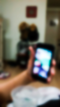 A woman talk face to face with his son at night by phone. Blurred abstract form.の写真素材