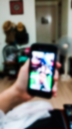 A woman talk face to face with his son at night by phone. Blurred abstract form.の写真素材
