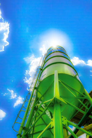 A concrete plant, also known as a batch plant or batching plant or a concrete batching plant. Large concrete plant on sunny days, beautiful, beautiful, fresh blue. Abstract blur.の写真素材