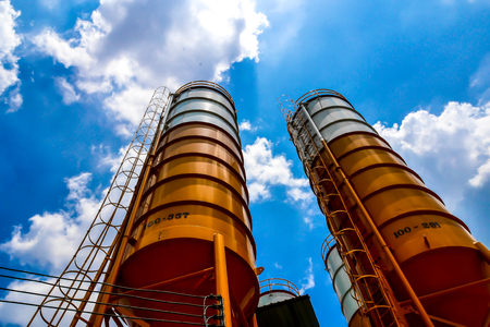 A concrete plant, also known as a batch plant or batching plant or a concrete batching plant. Large concrete plant on sunny days, beautiful, beautiful, fresh blue. Abstract blur.の写真素材