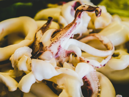Spicy Thai food, steamed squid, lemon. Seafood food at a seaside restaurant. Abstract image,...