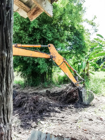 Yellow loader digging or plowing to open the top of the soil for farming and weeding out. abstract...