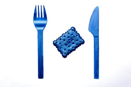 spoon, a fork and a blue biscuit