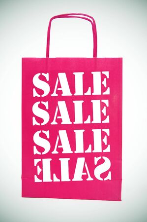 colored paper bag isolated writing the saleの写真素材